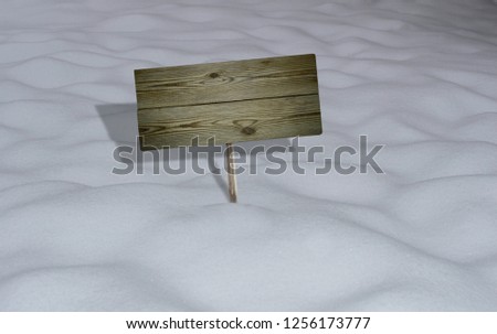 Wooden billboard sticks out of the snow