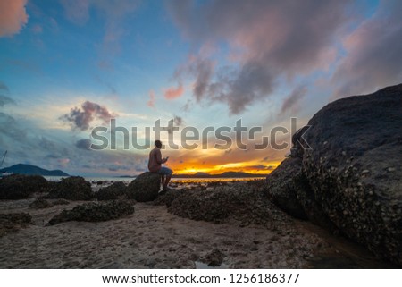 sunrise above the sea one man selfie on the rock 