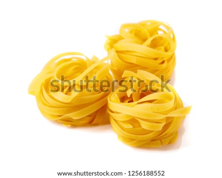 Homemade raw egg noodles isolated on a white background.