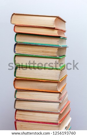 stack of old books in the library on a light background