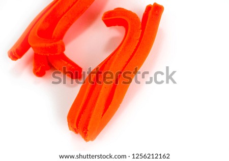 Orange plasticine for children's creativity on a white background.