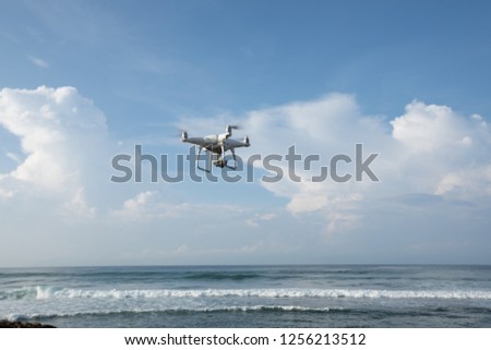 Flying drone which taking photo over sea 