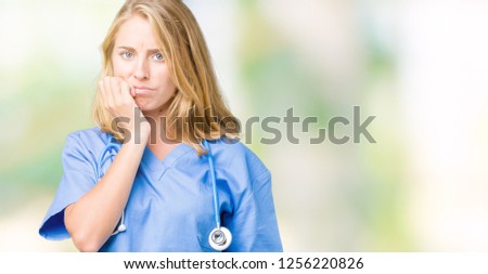Beautiful young doctor woman wearing medical uniform over isolated background looking stressed and nervous with hands on mouth biting nails. Anxiety problem.