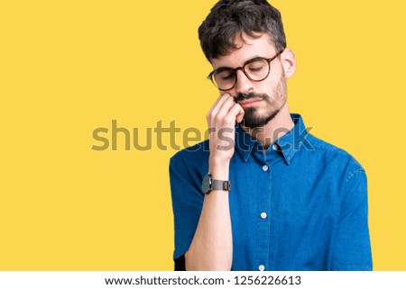 Young handsome man wearing glasses over isolated background thinking looking tired and bored with depression problems with crossed arms.