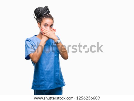 Young braided hair african american girl professional nurse over isolated background shocked covering mouth with hands for mistake. Secret concept.