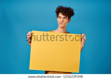a man holding a yellow sheet of paper in disgust Poster mockup                   