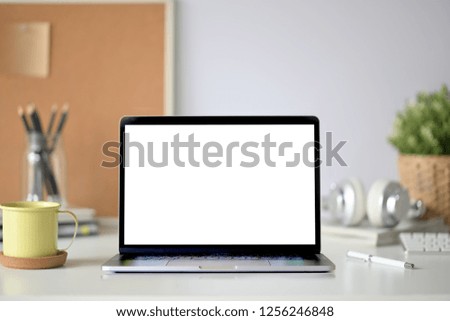 Blank screen laptop computer on workspace 