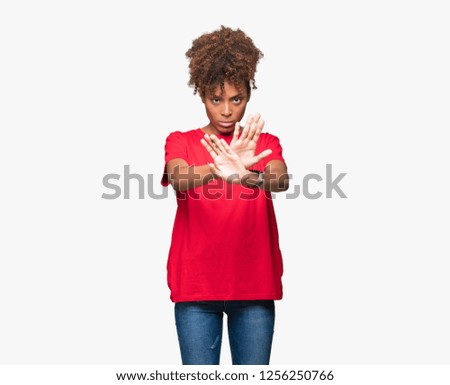 Beautiful young african american woman over isolated background Rejection expression crossing arms and palms doing negative sign, angry face