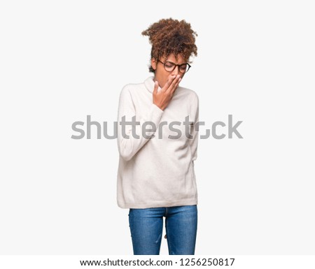 Beautiful young african american woman wearing glasses over isolated background bored yawning tired covering mouth with hand. Restless and sleepiness.