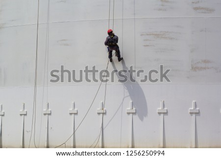 Male worker rope access  inspection of thickness shell plate storage tank industry