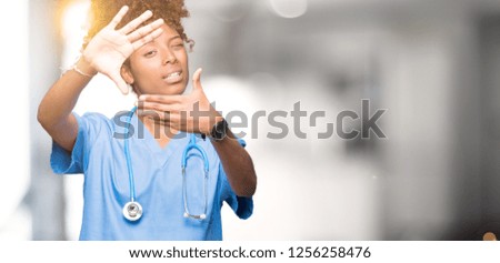 Young african american doctor woman over isolated background Smiling doing frame using hands palms and fingers, camera perspective