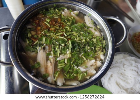 Vietnamese red tilapia hotpot. Stock is cooked from pork bone & lime. Fresh fish is served with vegetable when order. It is then cooked in a hotpot. We can eat it with fish sauce, vermicelli, noodles