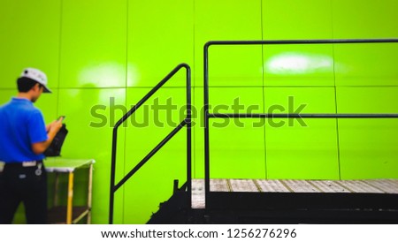 Banner Advertising Engineer is repairing machine in factory. With stairs up the way For the machine. And space for entering pictures or entering text. make people sideways blurry. Copy space concept.