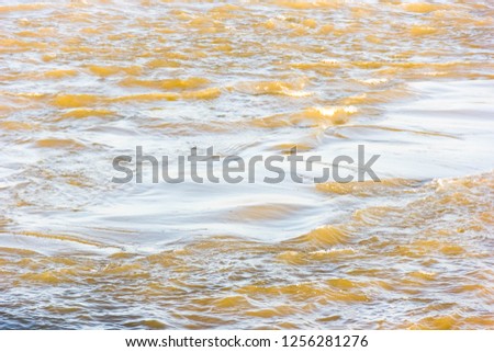The sun shines on the waves, the golden waves