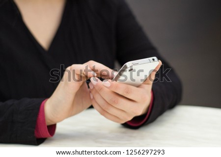 female hand holding a mobile phone close-up
