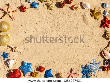 Christmas background on the beach with shells on the sand. Selective focus.
