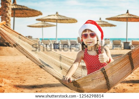 child on the beach in santa hat. Selective focus. holidays.