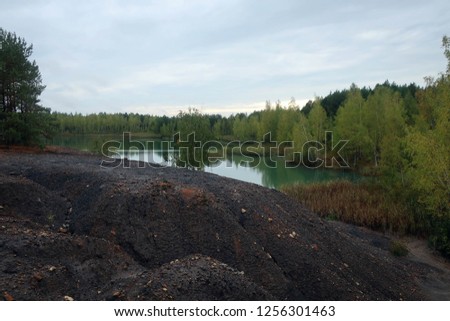 Scenic landscape of forest and sand hills near clay quarry, Suvorov, Russia