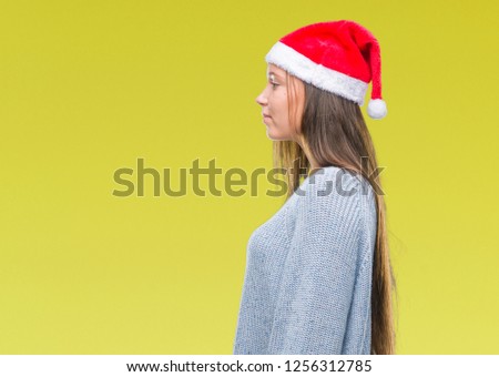 Young beautiful caucasian woman wearing christmas hat over isolated background looking to side, relax profile pose with natural face with confident smile.