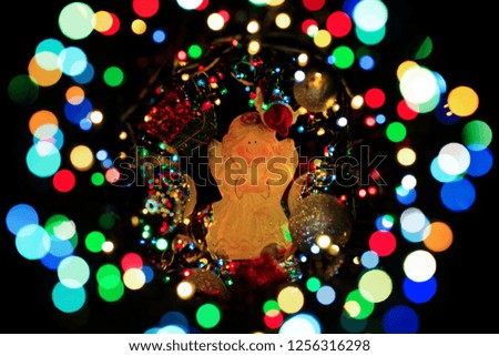 Abstract holiday lights garlands. Photographed with shallow depth of field. The background is blurred and dark.