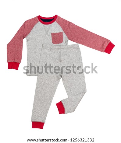 Sleepwear set on white background. Shirt and pants made of gray/red/blue cotton fabric. Pajama for boy. Flat lay. Top view.  Royalty-Free Stock Photo #1256321332