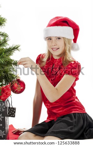 Portrait of a girl touching christmas tree against white background