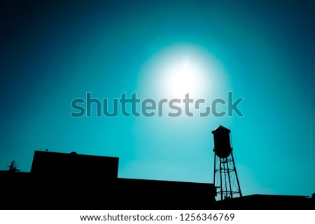 Silhouette of a wheal farm container on a blue background. Classic farm picture. Mystic light.