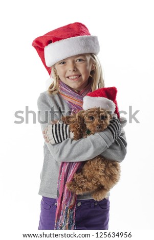 Portrait of a smiling girl carrying a puppy over white background