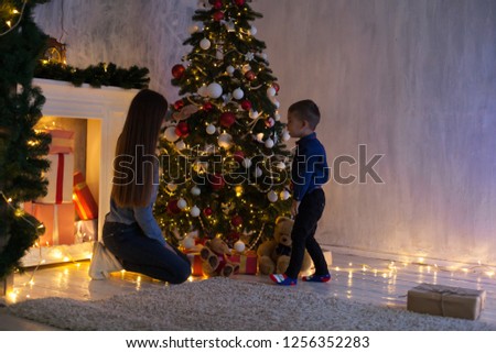 little boy with mom decorate the Christmas tree new year holiday
