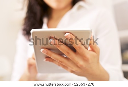 Corporate woman with portable tablet pc on her hand