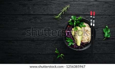 Rice with avocado and cabbage. Healthy food. Top view. On a black background. Free copy space.
