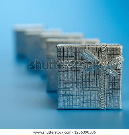 festive silver gift boxes on a blue background.
Christmas composition.