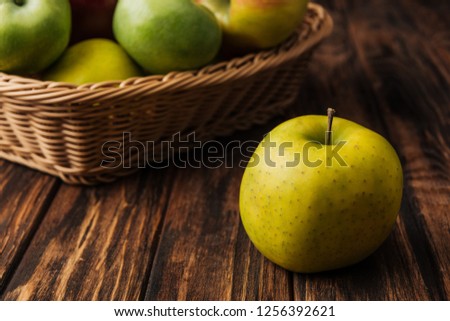 golden delicious apple with fruit wicker basket at background