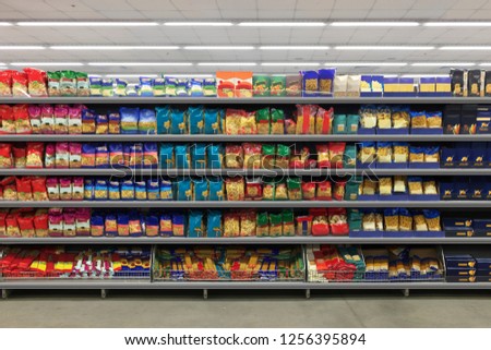 Pasta Packaging on a shelf in a supermarket. is suitable for presenting new packaging among many others. Royalty-Free Stock Photo #1256395894