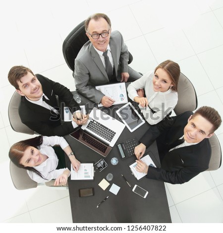 top view.business team at a Desk looking at the camera