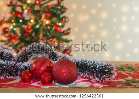 Christmas ornaments with tree and festive bokeh lighting, blurred holiday background.