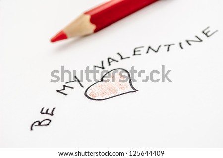 Handwritten Valentine message with a heart on a white paper.