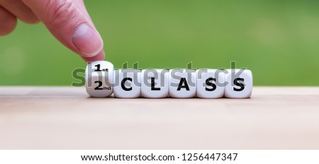Hand is turning a dice and changes the word "2nd Class" to "1st Class"