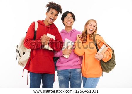 Image of a happy young group of friends students standing isolated over white wall background posing.