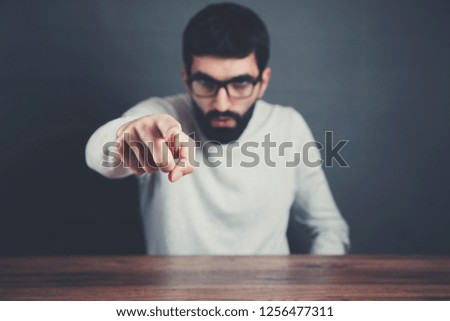 man hand in you sign on gray background