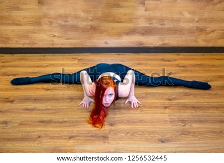 Fitness, stretching workout, attractive happy woman working out in sports club, keeping fit, doing Wide-Angle Seated Forward Bend pose, Upavishtha Konasana posture in class - Picture