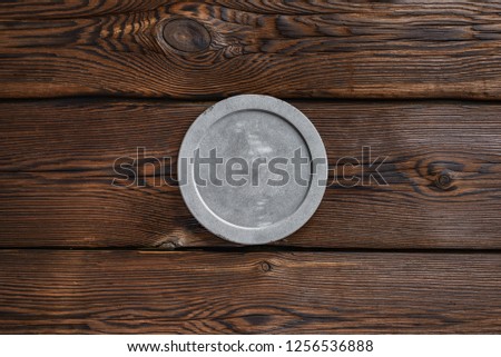 grey concrete round signboard on dark wooden brown background