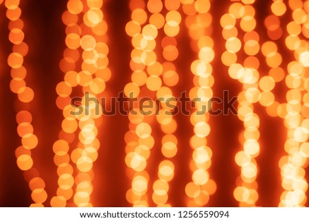 Yellow Christmas Tree Bokeh on black background of defocused glittering lights, Christmas background pattern concept.