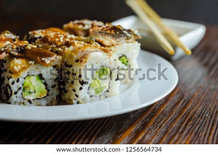 sushi rolls with eel, cheese and avocado