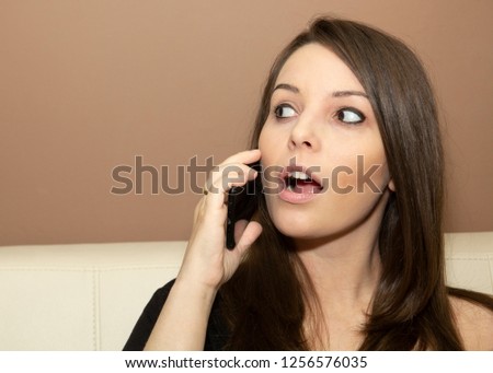 
Young beautiful woman talking on a smartphone