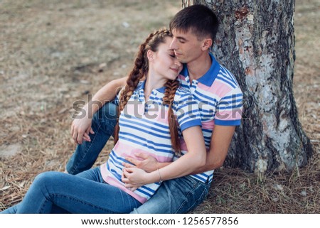Young couple laying on park lawn