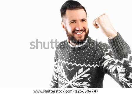 happy man with a beard, a man depicts a gesture of victory and success, on a white background.