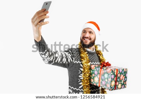 a man takes a picture with a Christmas gift