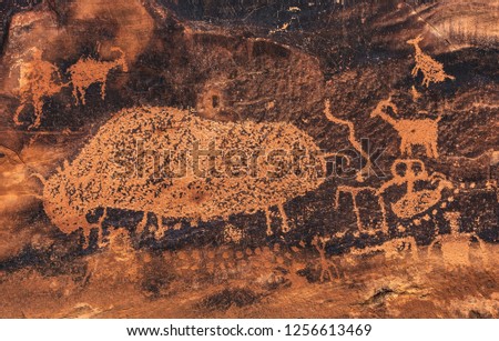 The "Big Buffalo" petroglyph rock art panel in Nine Mile Canyon, near Price, Utah, USA.  Called the "world's longest art gallery," the art was made over 1000+ years by Archaic Fremont and modern Ute. Royalty-Free Stock Photo #1256613469