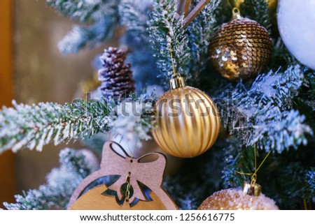 Bright festive decorations celebrating Christmas and New Year with empty space. Christmas toys, glass balls and garlands on the Christmas branches. Soft focus and beautiful bokeh.